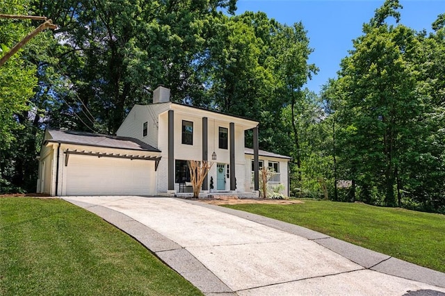 view of front of property with a garage and a front lawn