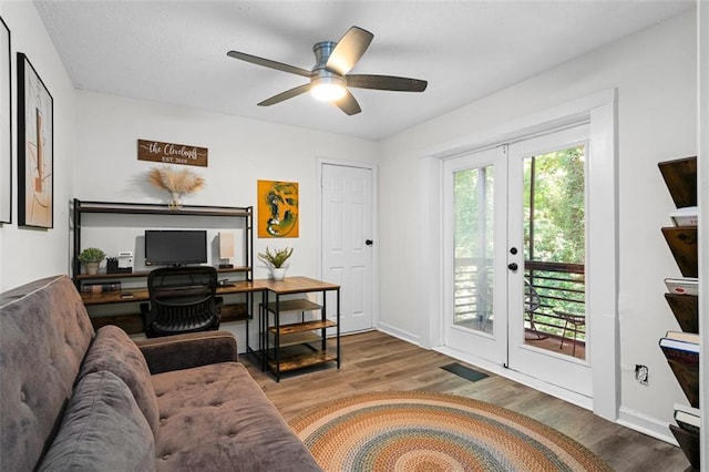 home office featuring french doors, hardwood / wood-style flooring, and ceiling fan