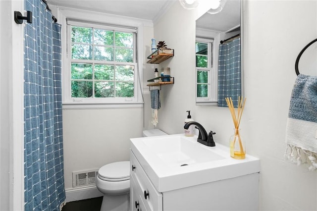 bathroom with a shower with curtain, vanity, toilet, and ornamental molding