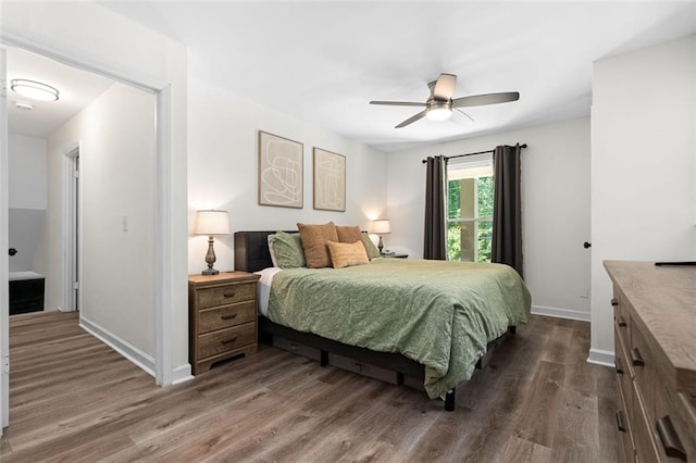 bedroom featuring ceiling fan and dark hardwood / wood-style flooring