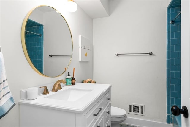 bathroom with vanity, toilet, and a shower