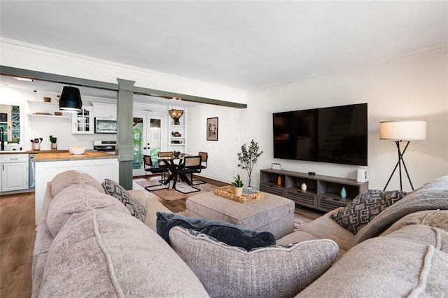 living room featuring hardwood / wood-style flooring, french doors, and ornamental molding