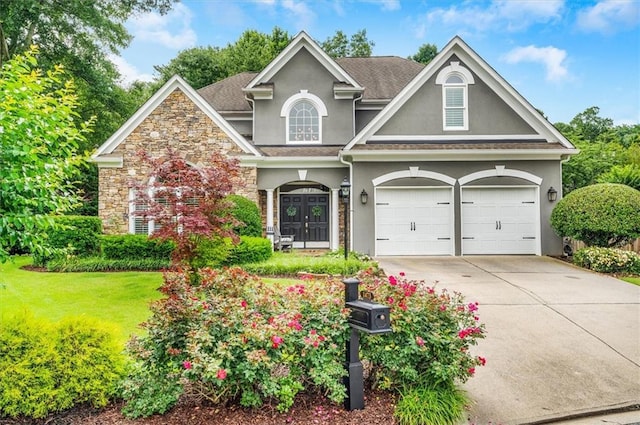 1473 Cardova Pointe, Dunwoody, GA 30338 - view of front of home featuring stucco siding, stone siding, driveway, a front lawn, and an attached garage