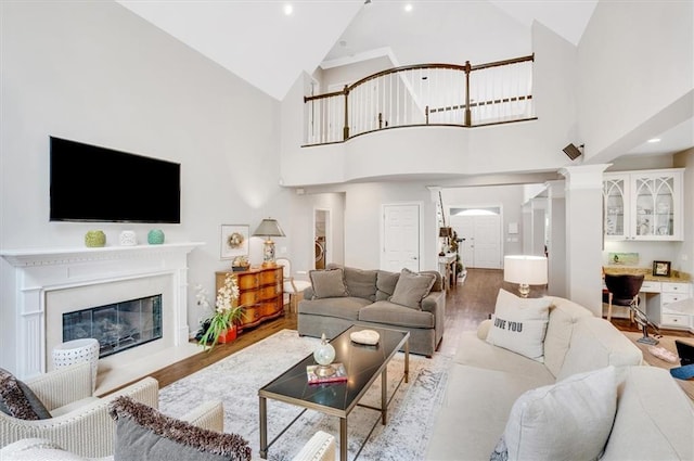 1473 Cardova Pointe, Dunwoody, GA 30338 - living area featuring wood finished floors, high vaulted ceiling, and a glass covered fireplace