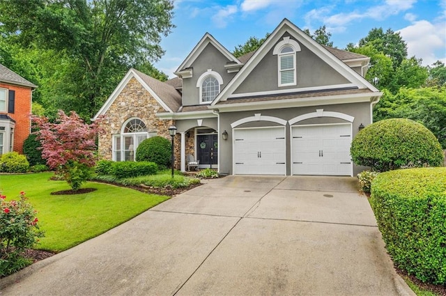 1473 Cardova Pointe, Dunwoody, GA 30338 - traditional home featuring stucco siding, stone siding, concrete driveway, a front lawn, and an attached garage