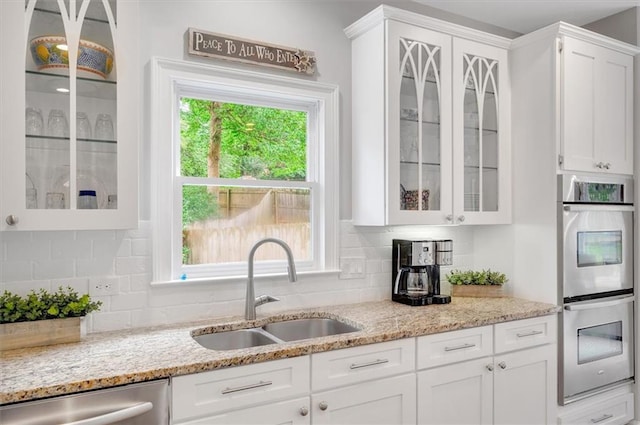 1473 Cardova Pointe, Dunwoody, GA 30338 - kitchen with stainless steel appliances, white cabinetry, and glass insert cabinets