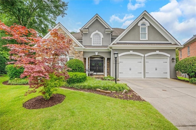1473 Cardova Pointe, Dunwoody, GA 30338 - view of front facade with stucco siding, a front lawn, stone siding, concrete driveway, and an attached garage