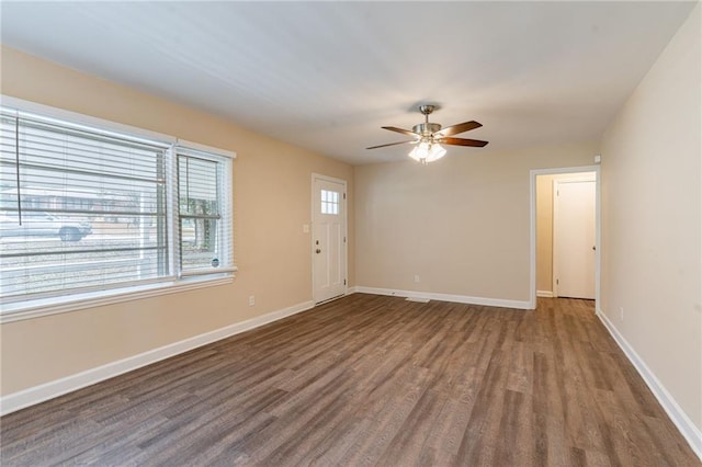 spare room with dark hardwood / wood-style floors and ceiling fan