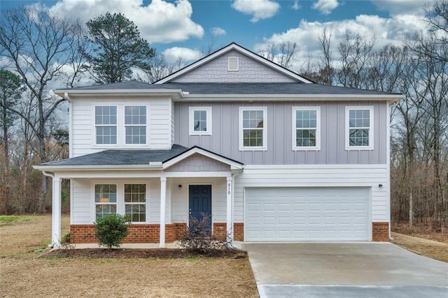 view of front of home with board and batten siding, an attached garage, brick siding, and driveway