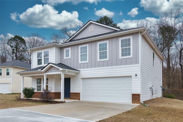 view of front of home with brick siding, an attached garage, concrete driveway, and board and batten siding