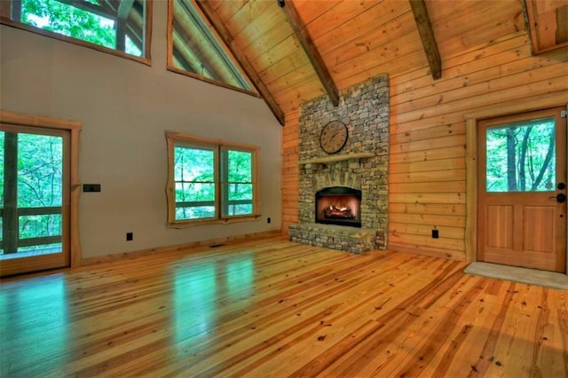 179 Huckleberry Ln, Ellijay, GA 30536 - unfurnished living room with high vaulted ceiling, hardwood / wood-style flooring, beamed ceiling, wood ceiling, and a stone fireplace