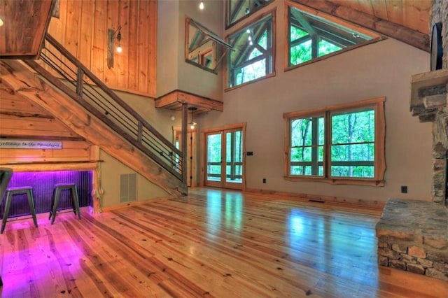 179 Huckleberry Ln, Ellijay, GA 30536 - unfurnished living room featuring stairway, hardwood / wood-style flooring, and high vaulted ceiling