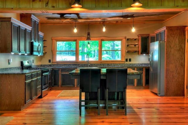 179 Huckleberry Ln, Ellijay, GA 30536 - kitchen featuring stainless steel appliances, dark countertops, light wood-style floors, open shelves, and a sink