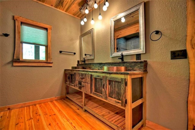 179 Huckleberry Ln, Ellijay, GA 30536 - bathroom with a textured wall, wood finished floors, wooden ceiling, double vanity, and baseboards