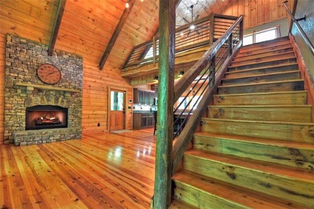 179 Huckleberry Ln, Ellijay, GA 30536 - staircase featuring high vaulted ceiling, wood ceiling, hardwood / wood-style flooring, beamed ceiling, and wood walls