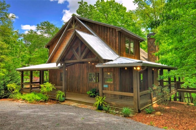 179 Huckleberry Ln, Ellijay, GA 30536 - view of front of house with metal roof and a sunroom