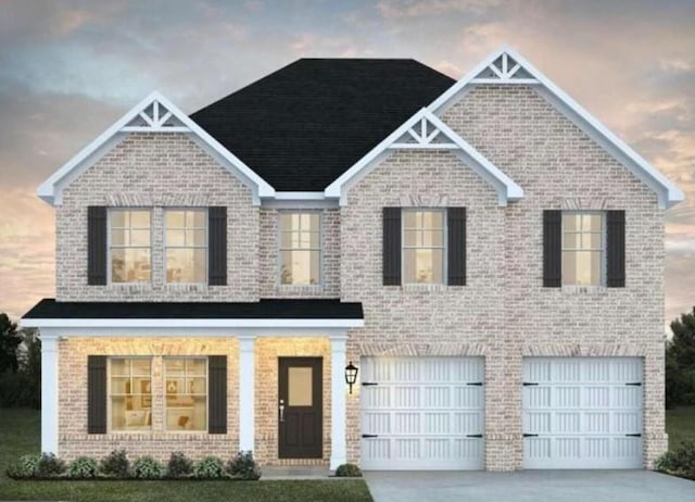 view of front of house featuring a garage, concrete driveway, and brick siding