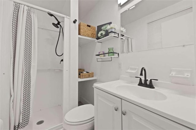 bathroom with toilet, a stall shower, and vanity