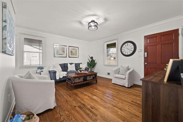 living area featuring a wealth of natural light, wood finished floors, and crown molding