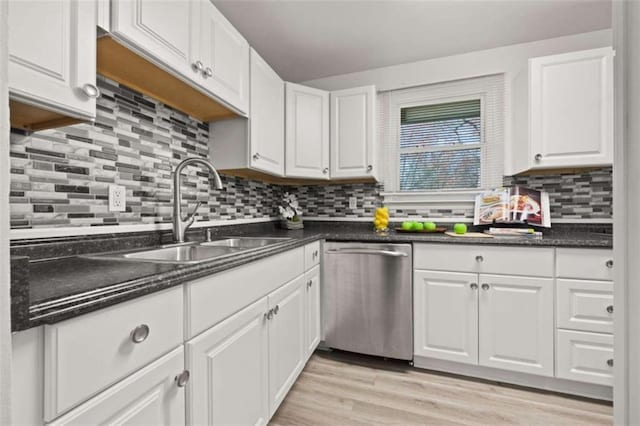 kitchen with a sink, white cabinetry, light wood-type flooring, and stainless steel dishwasher