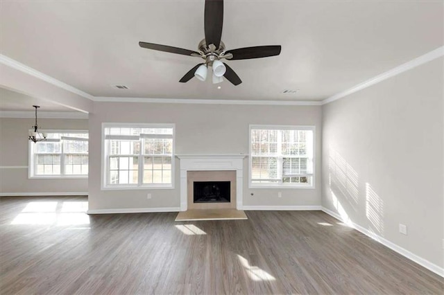 unfurnished living room with hardwood / wood-style flooring, crown molding, and ceiling fan with notable chandelier