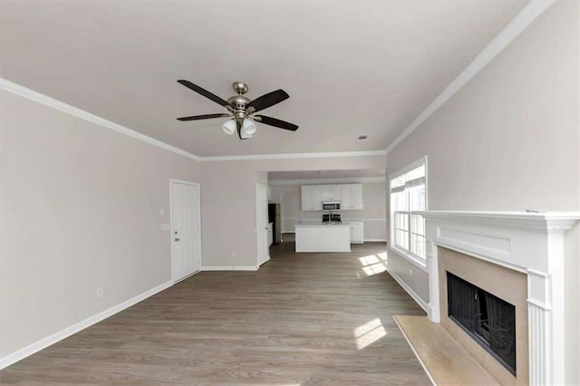 unfurnished living room featuring light hardwood / wood-style flooring, ornamental molding, and ceiling fan