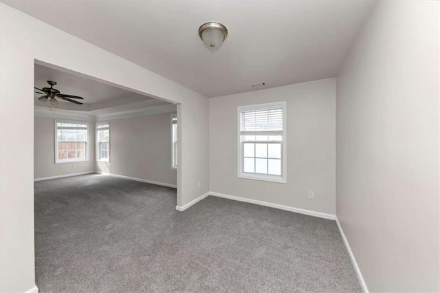 spare room featuring dark colored carpet