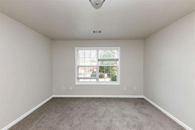 unfurnished room featuring light carpet