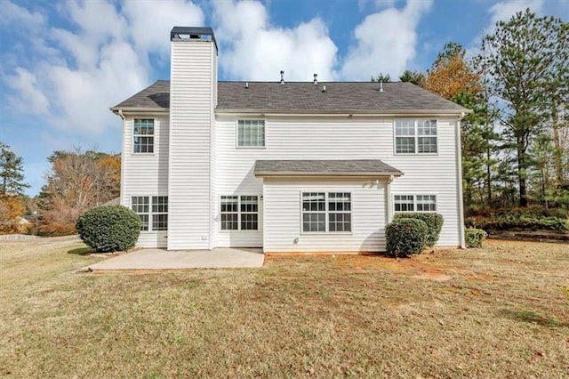 rear view of house featuring a yard and a patio area