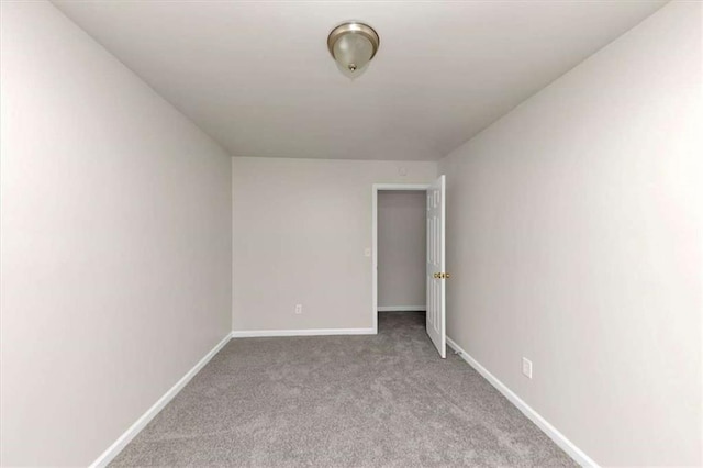 unfurnished room featuring light carpet