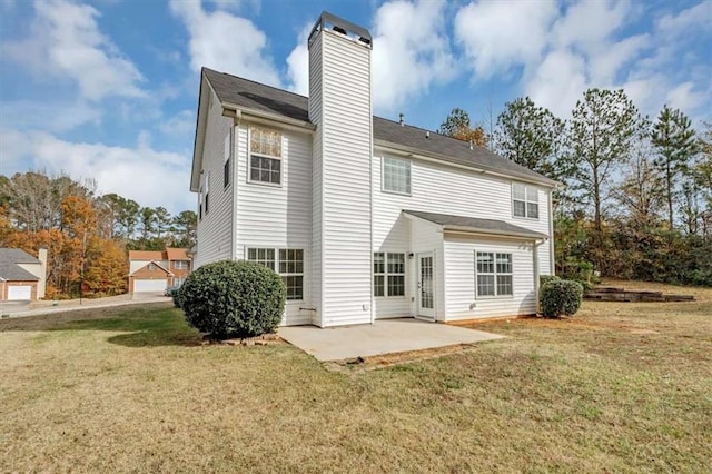 rear view of house with a patio area and a lawn