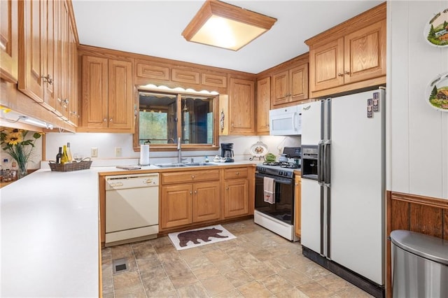 kitchen featuring white appliances and sink