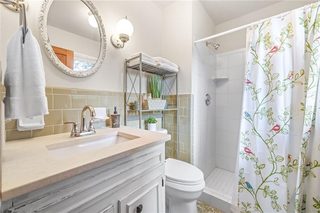 bathroom with toilet, tile walls, vanity, and walk in shower