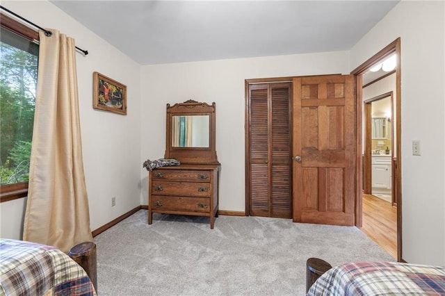 bedroom featuring light colored carpet and a closet