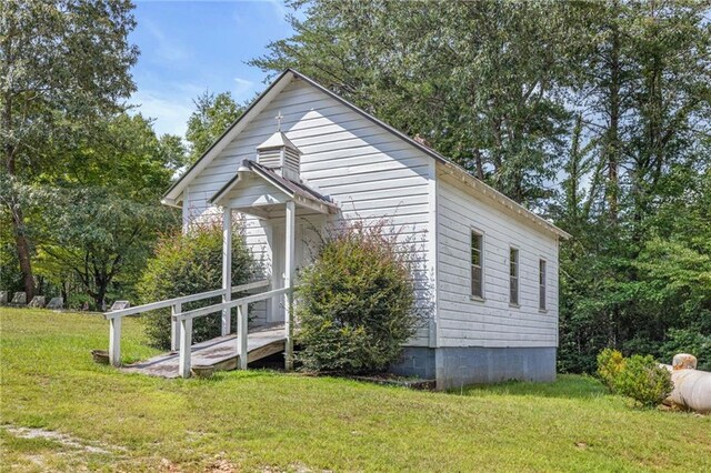 view of side of property with a yard