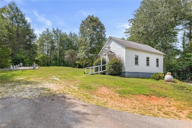 view of home's exterior with a yard