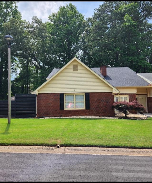 6210 Douglas Manor Ct, Douglasville, GA 30134 - view of home's exterior featuring brick siding and a chimney