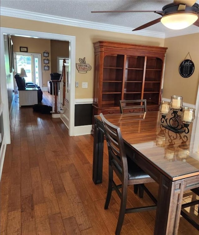 6210 Douglas Manor Ct, Douglasville, GA 30134 - dining room featuring dark wood-type flooring, a textured ceiling, a ceiling fan, and ornamental molding