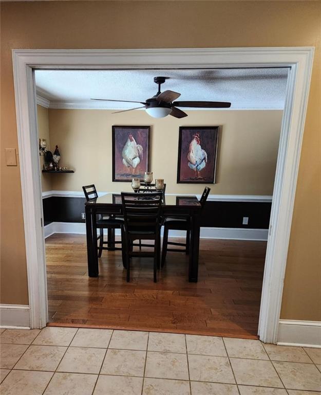 6210 Douglas Manor Ct, Douglasville, GA 30134 - dining area with baseboards, ceiling fan, light tile patterned flooring, and ornamental molding
