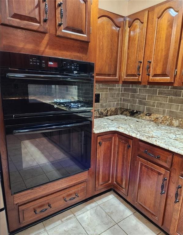 6210 Douglas Manor Ct, Douglasville, GA 30134 - kitchen featuring tasteful backsplash, light stone counters, and brown cabinets