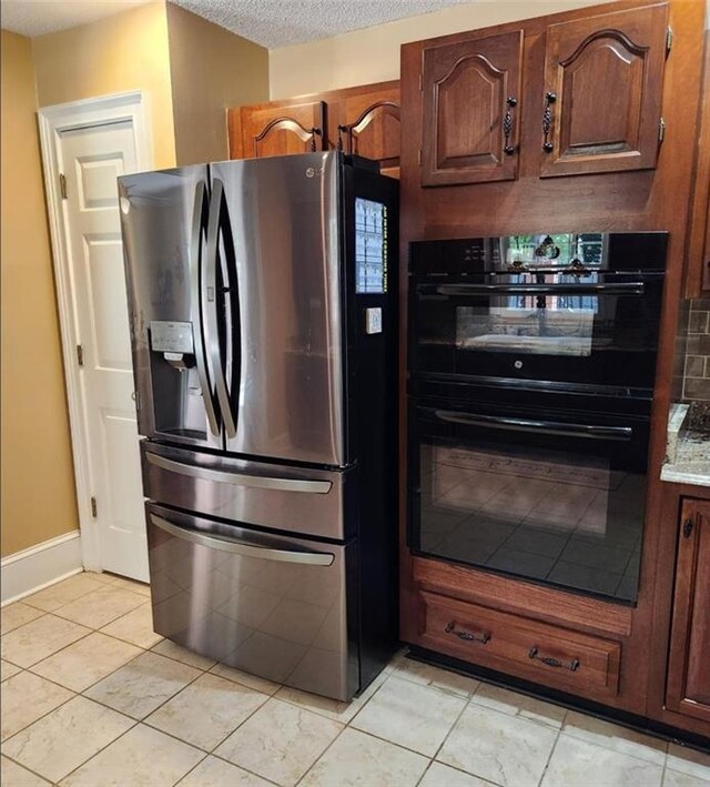 6210 Douglas Manor Ct, Douglasville, GA 30134 - kitchen featuring stainless steel refrigerator with ice dispenser, light tile patterned floors, a textured ceiling, and baseboards