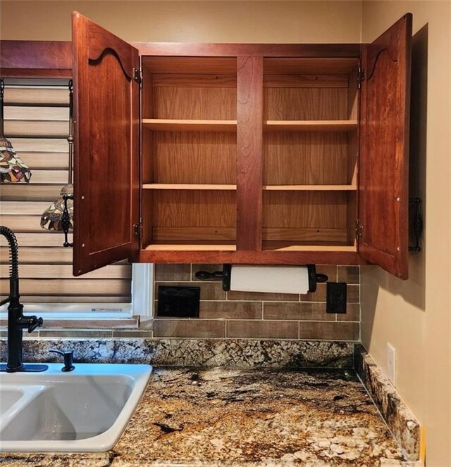 6210 Douglas Manor Ct, Douglasville, GA 30134 - kitchen view of a sink, decorative backsplash, open shelves, and dark stone counters