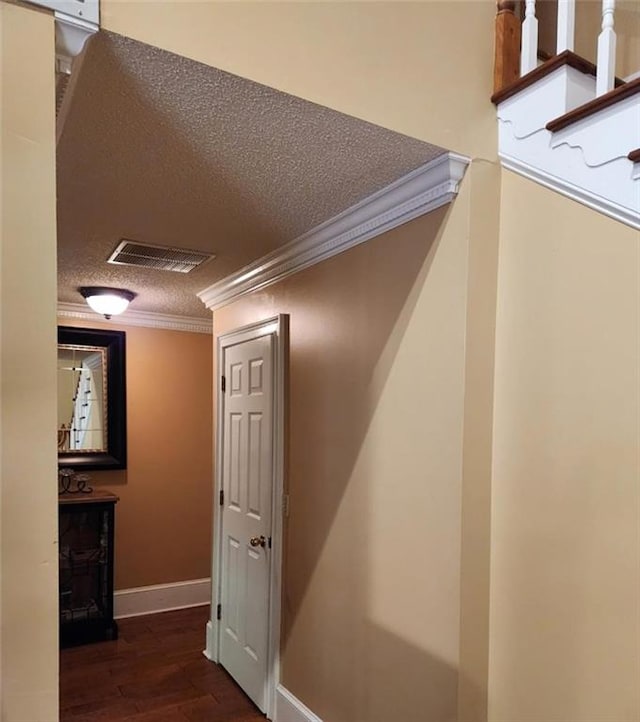 6210 Douglas Manor Ct, Douglasville, GA 30134 - hall with crown molding, wood finished floors, a textured ceiling, baseboards, and stairway