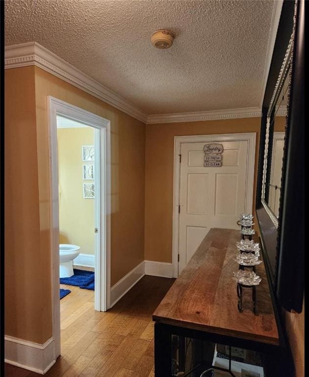 6210 Douglas Manor Ct, Douglasville, GA 30134 - corridor featuring baseboards, ornamental molding, hardwood / wood-style floors, and a textured ceiling