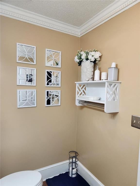 6210 Douglas Manor Ct, Douglasville, GA 30134 - bathroom featuring ornamental molding, toilet, baseboards, and a textured ceiling