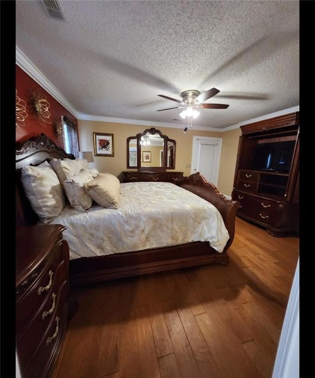 6210 Douglas Manor Ct, Douglasville, GA 30134 - bedroom with dark wood-type flooring, a textured ceiling, crown molding, and a ceiling fan