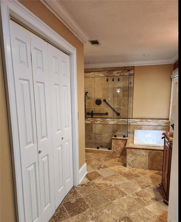 6210 Douglas Manor Ct, Douglasville, GA 30134 - full bathroom featuring a shower stall, a jetted tub, crown molding, a closet, and a textured ceiling