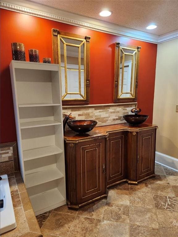 6210 Douglas Manor Ct, Douglasville, GA 30134 - bathroom with backsplash, double vanity, a textured ceiling, recessed lighting, and a bath