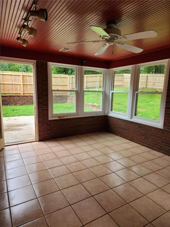 6210 Douglas Manor Ct, Douglasville, GA 30134 - unfurnished sunroom with brick wall, ceiling fan, healthy amount of natural light, and tile patterned floors