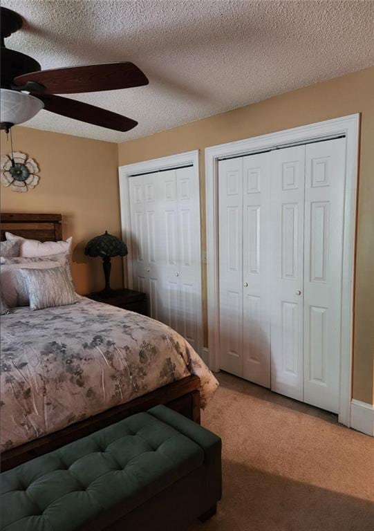 6210 Douglas Manor Ct, Douglasville, GA 30134 - bedroom with two closets, carpet flooring, a textured ceiling, and ceiling fan